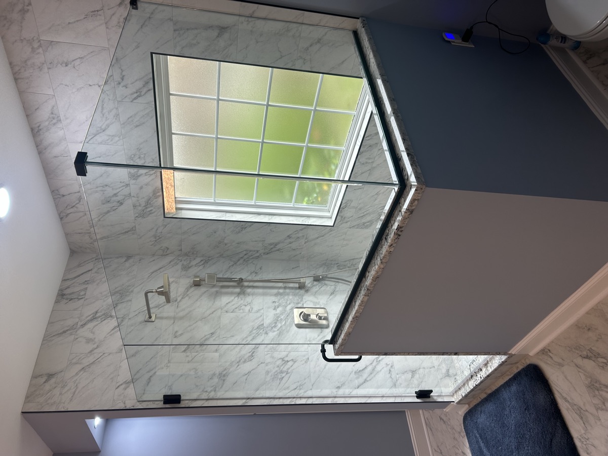Semi-frameless shower door over a tub