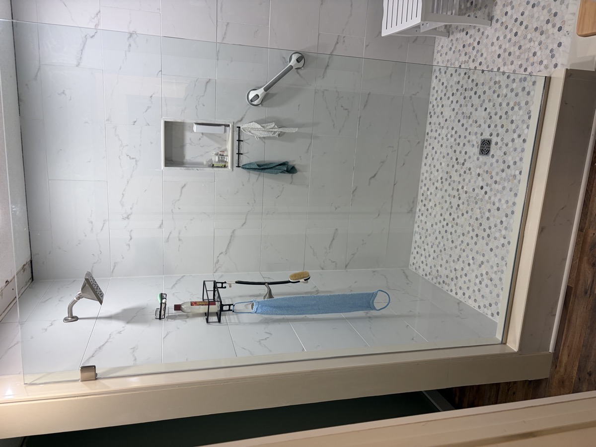 Clear glass shower enclosure in a coastal bathroom