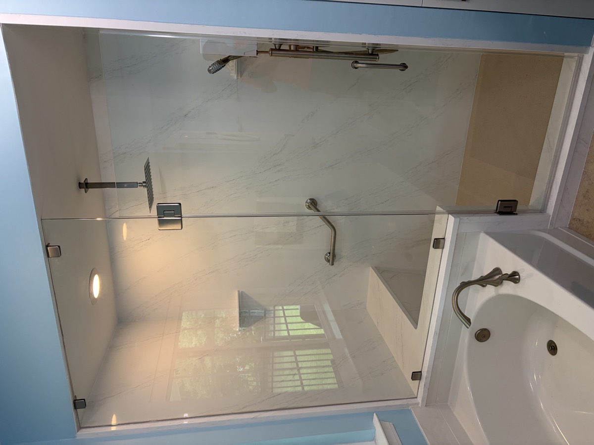 A bright bathroom finished with a custom glass shower door